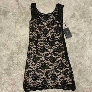 Cute little black lace dress with nude lining.   Size M.
